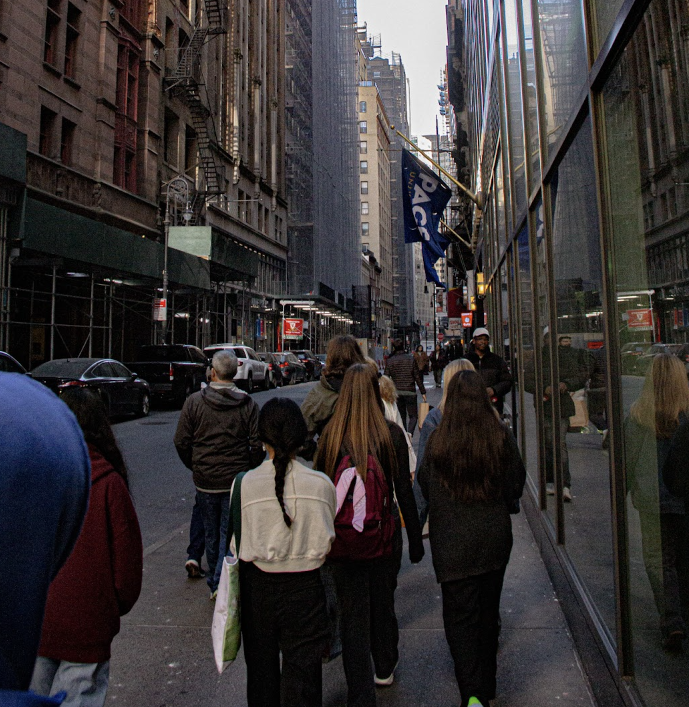 The students walking through Wall Street.